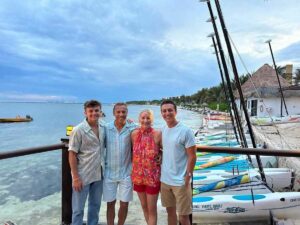 2024 Cancun, Donna & her family beside the Sailing Club